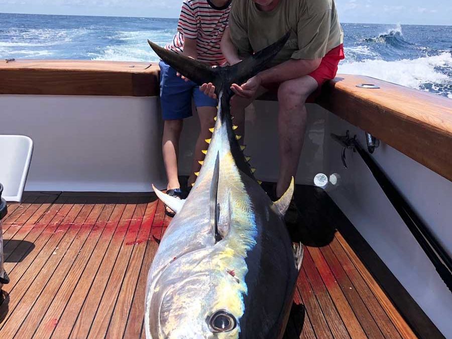 Man and boy Yellowfin Tuna Fish catch on Charter Fishing Boat