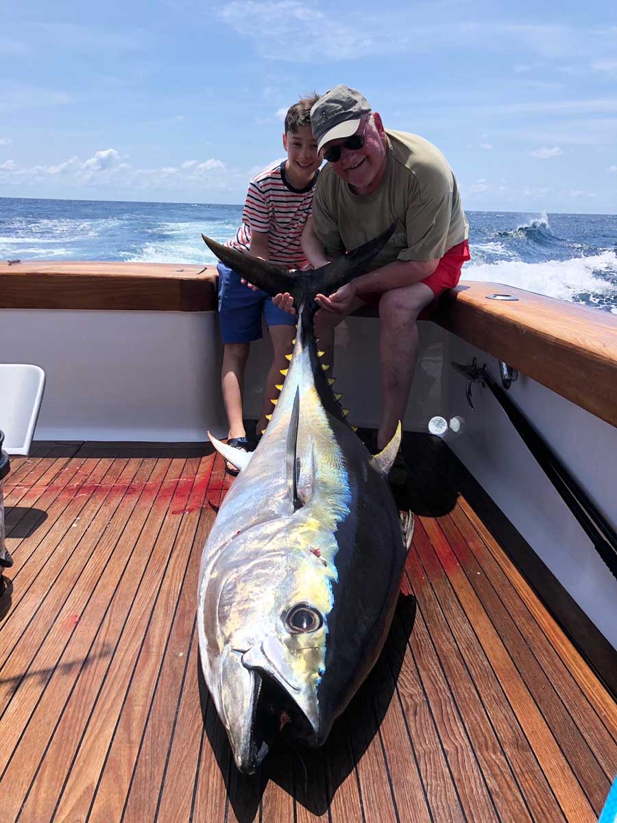 Man and boy Yellowfin Tuna Fish catch on Charter Fishing Boat